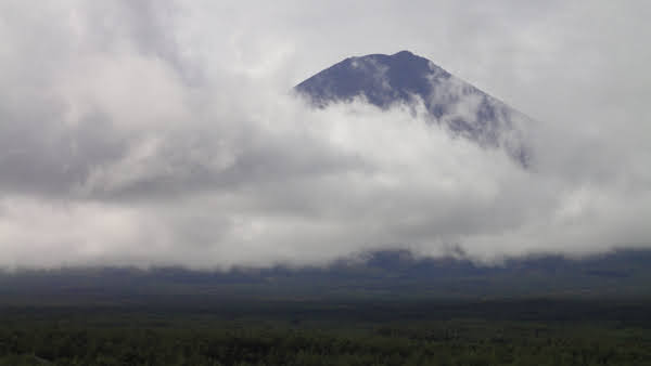 mount fuji mostly covered in clouds
